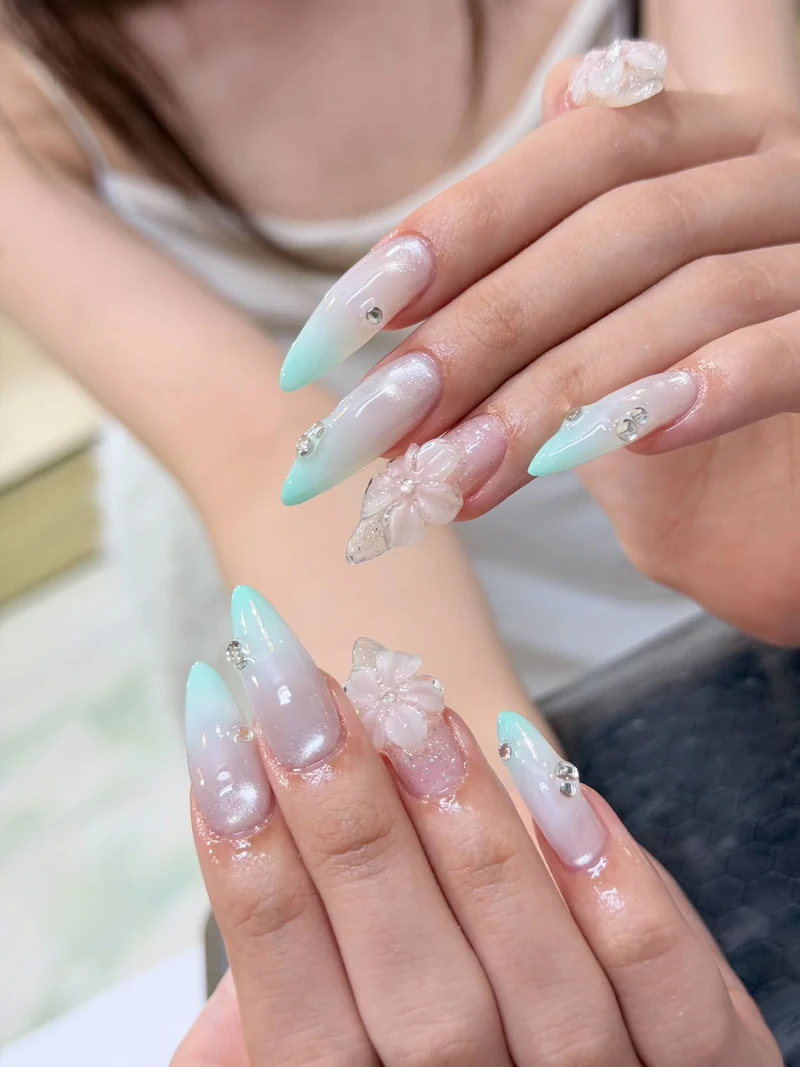 Pastel mint and pink nails with sculptural floral decoration from the supplied LENA collection