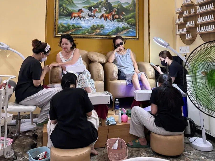 Guests receiving pedicure services in a LENA salon